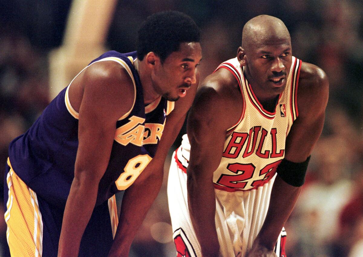 Los Angeles Lakers guard Kobe Bryant, left, and Chicago Bulls guard Michael Jordan talk during a free-throw attempt during the fourth quarter Dec. 17, 1997 at the United Center in Chicago. (Vincent Laforet/AFP/Getty Images/TNS) ** OUTS - ELSENT, FPG, TCN - OUTS **