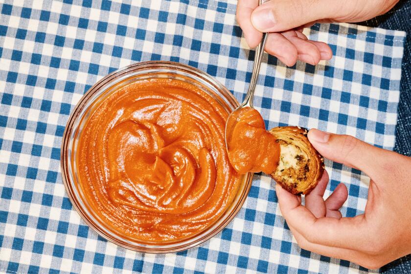 Curtis Stone prepares tomato sauce and sausage rolls - an Australian specialty and a childhood favorite - in the L.A. Times Test Kitchen.