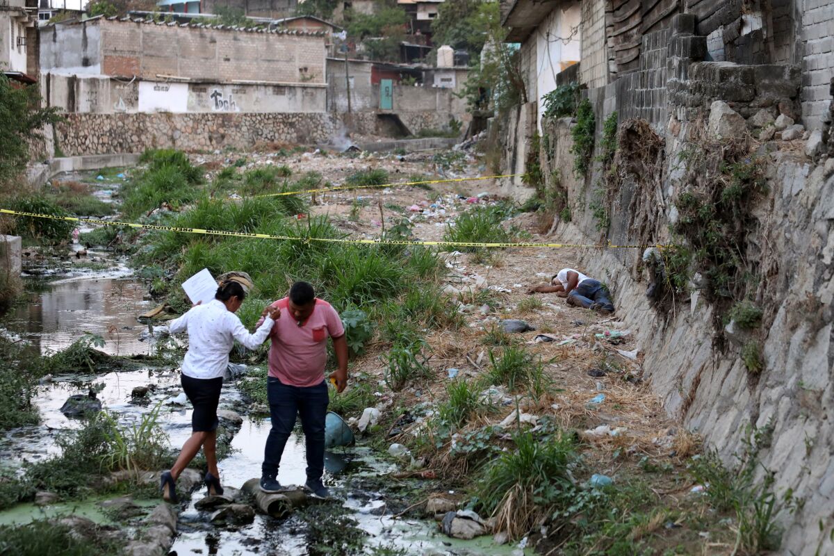 Investigators at a homicide scene in Acapulco.