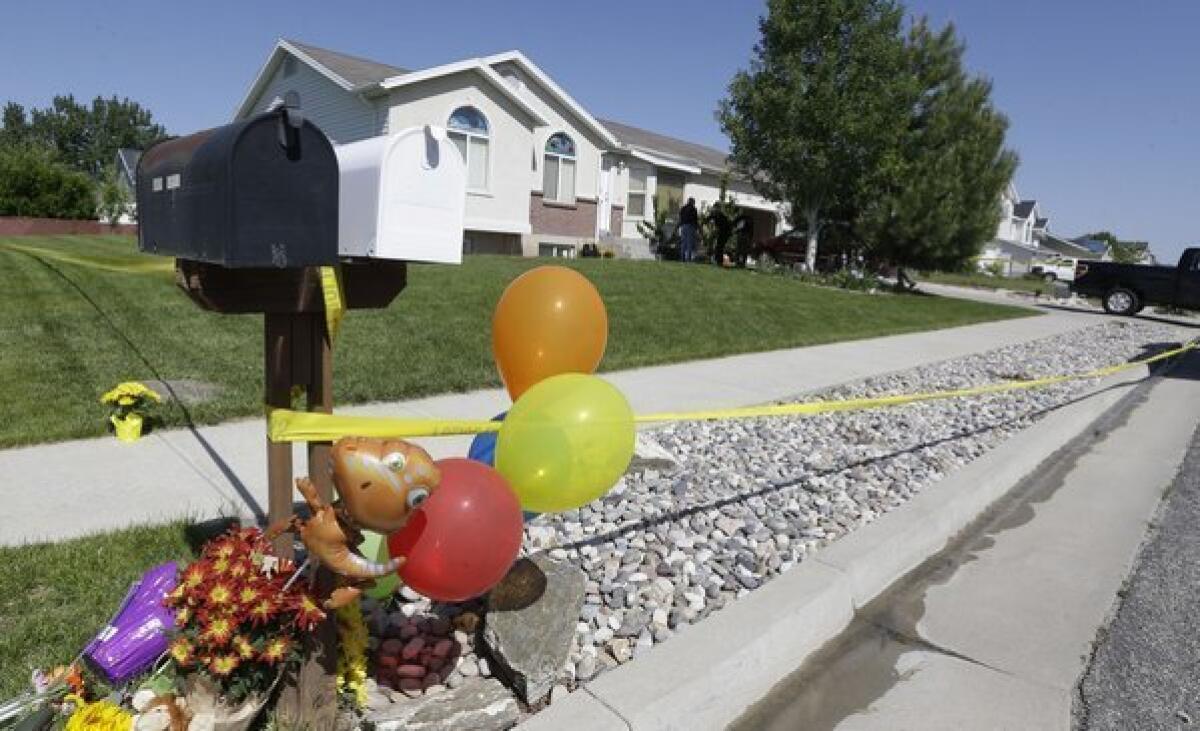 A 15-year-old boy was arrested in connection with the stabbing deaths of his two younger brothers, 4 and 10, at the family home in West Point, Utah. A memorial has take shape outside the home.