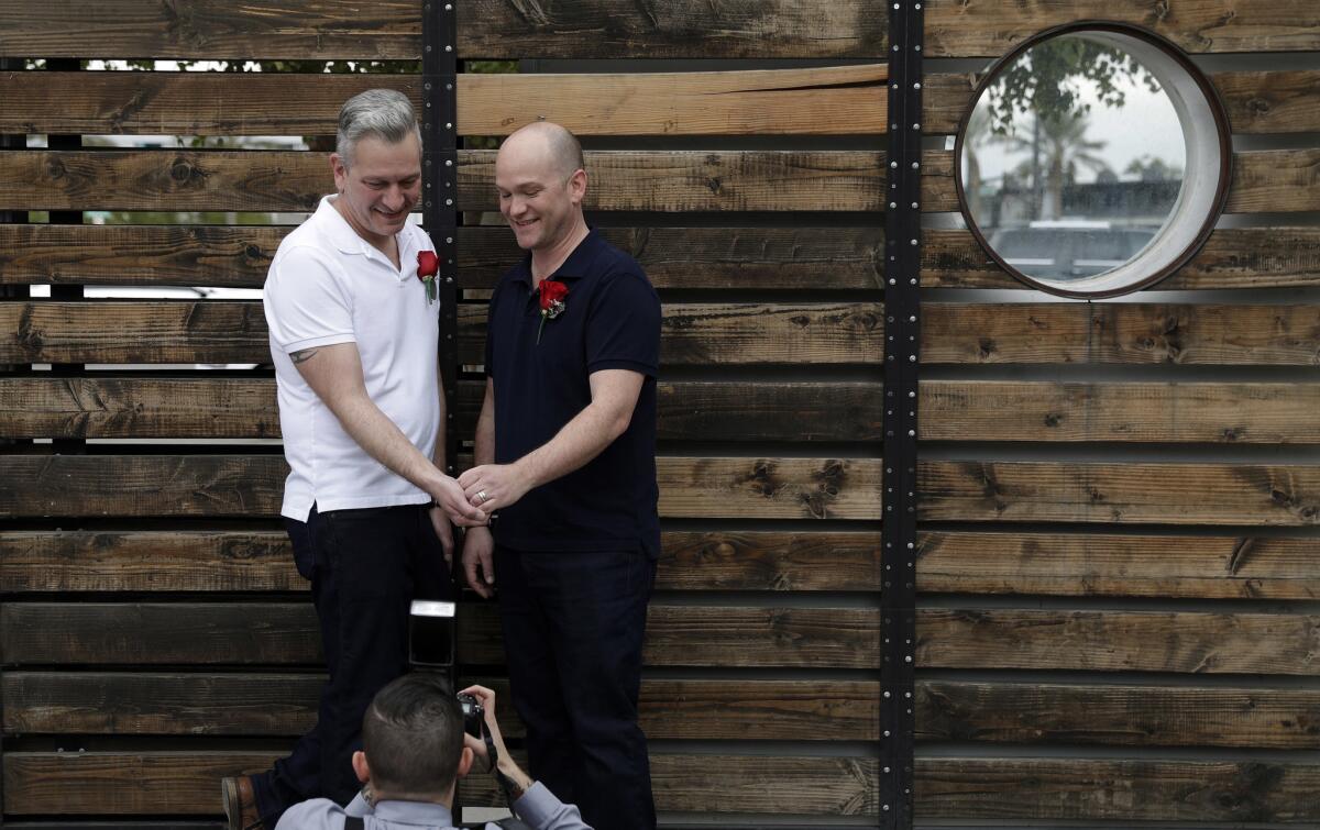 Stephan Maybroda, left, and Michael Maybroda of Delaware pose for photos after renewing their wedding vows for their 10th anniversary at the Elvis Wedding Chapel in Las Vegas on Wednesday.