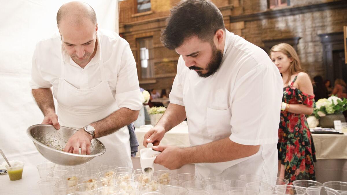 Vartan Abgaryan, executive chef, left, and Javier Lopez, chef de cuisine, of 71 Above, prepare crispy cauliflower with yuzu kasha bagna cauda pecorino, lime and dill during The Taste on the Paramount Studios backlot.