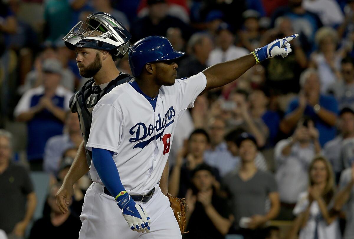 Yasiel Puig gestures to the stands after hitting a solo home run in the third inning against the Atlanta Braves. Puig has 13 home runs on the season.