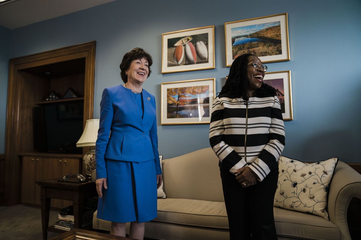 Supreme Court nominee Judge Ketanji Brown Jackson smiles broadly as she stands next to Sen. Susan Collins of Maine