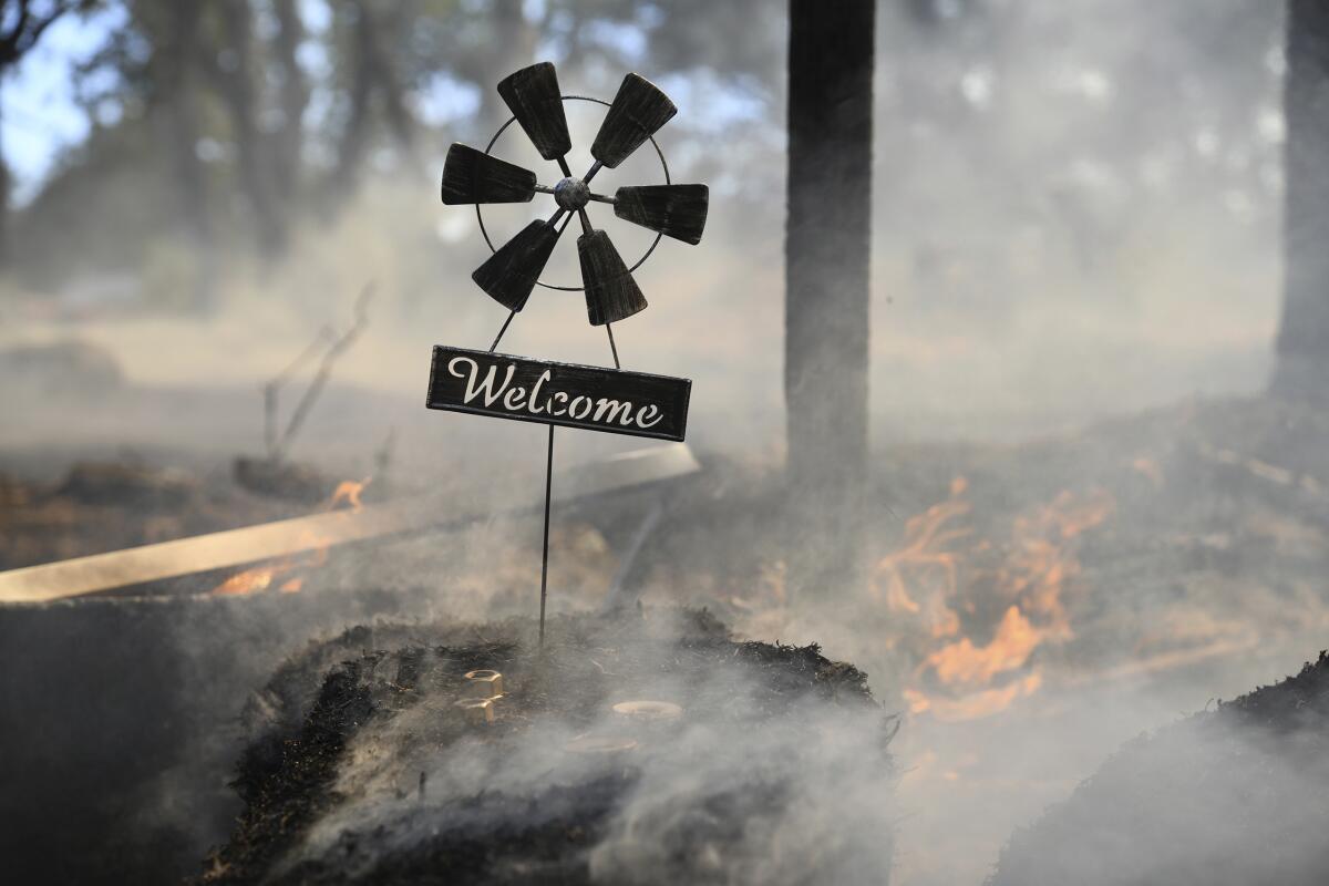 A welcome home sign sits at the front gate of a home saved by firefighters from the Rices fire.