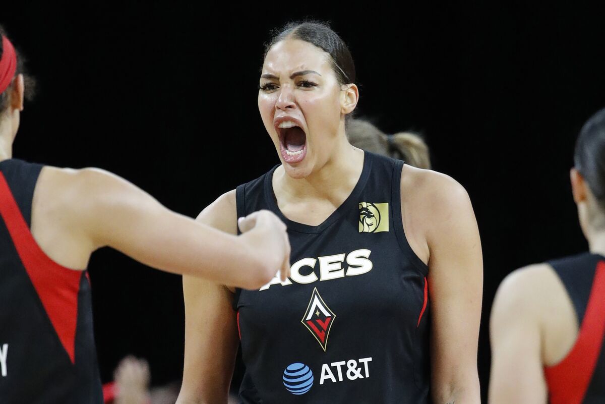 FILE - Las Vegas Aces' Liz Cambage, center, celebrates after a play against the Washington Mystics during the second half of Game 4 of a WNBA playoff basketball series in Las Vegas on Sept. 24, 2019. Cambage announced her unavailability in a frank Instagram post and was not included Monday, Dec. 6, 2021 among Australia's preliminary squad for next year’s Women’s Basketball World Cup. (AP Photo/John Locher, File)