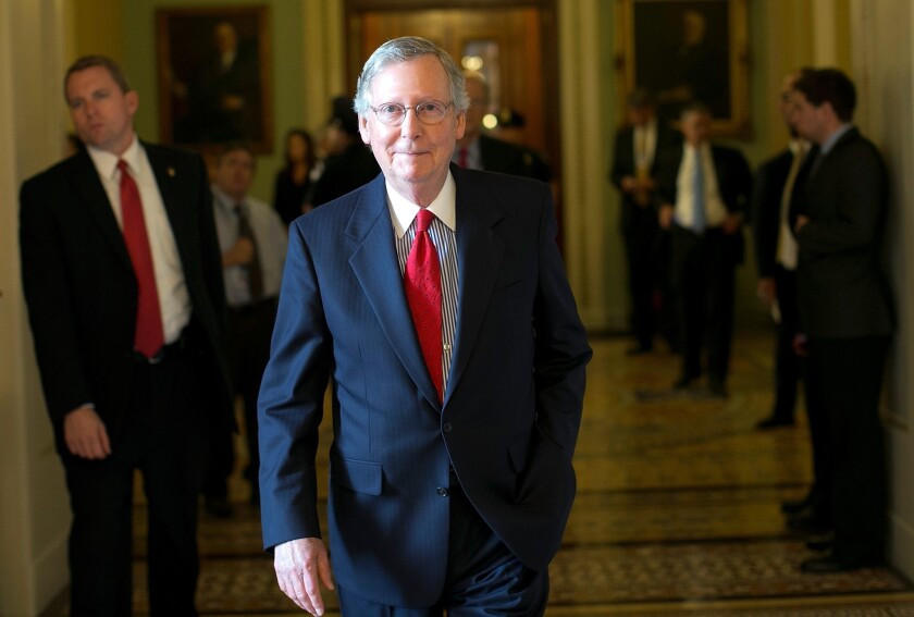 Senate Minority Leader Sen. Mitch McConnell (R-Kan.) returns to his office after a meeting of Senate Republicans at the Capitol in Washington.