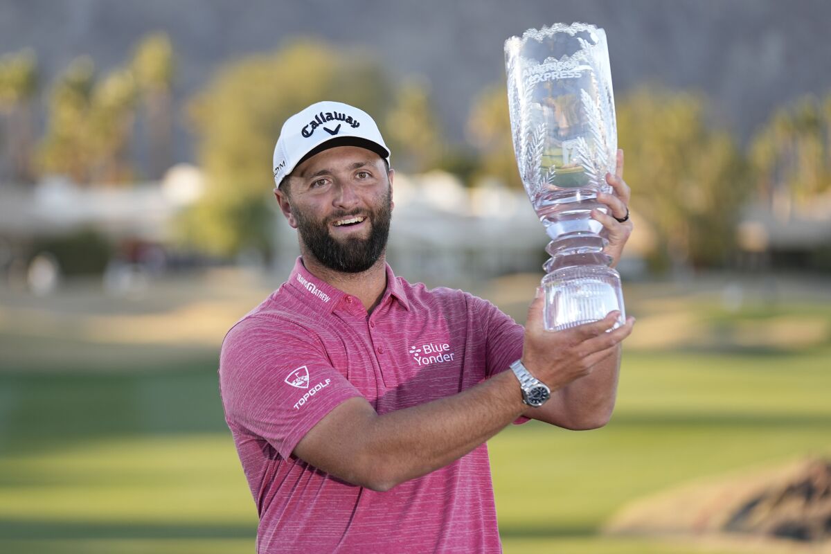 Jon Rahm hold the winner's trophy after the American Express golf tournament on the Pete Dye Stadium Course at PGA West Sunday, Jan. 22, 2023, in La Quinta, Calif. (AP Photo/Mark J. Terrill)