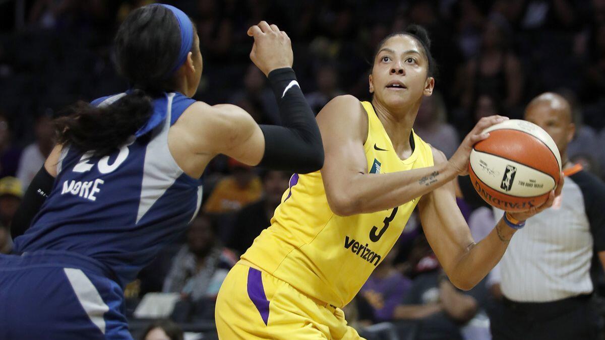 Sparks center Candace Parker shoots against Minnesota Lynx forward Maya Moore in the first quarter of an WNBA playoff game at Staples Center on Tuesday.