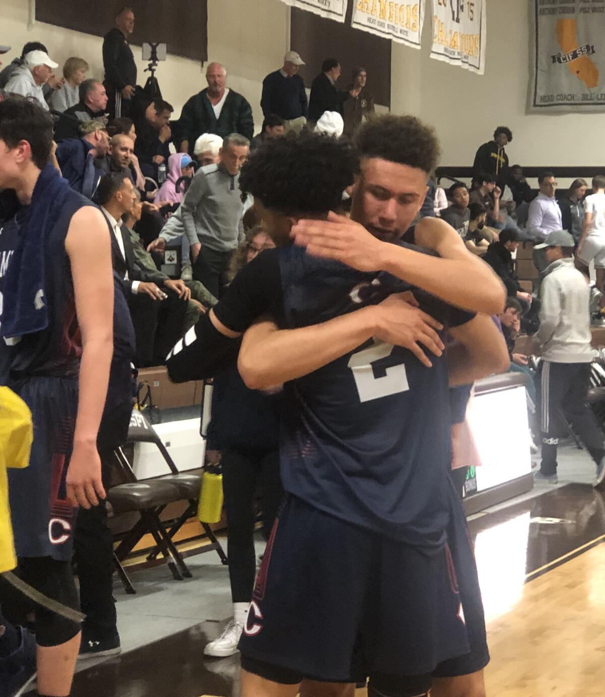 Kenneth Simpson Jr. (No. 2) receives hug from teammate Keith Higgins Jr. after scoring 41 points on Wednesday to help Chaminade defeat St. Francis 83-78 in the semifinals of the Mission League tournament.