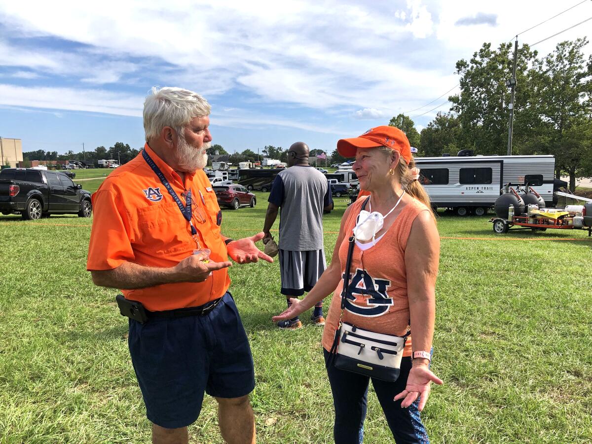 Larry Molt reunites ahead of Saturday's Auburn-Akron game with tailgating friend, Cindy Terry.