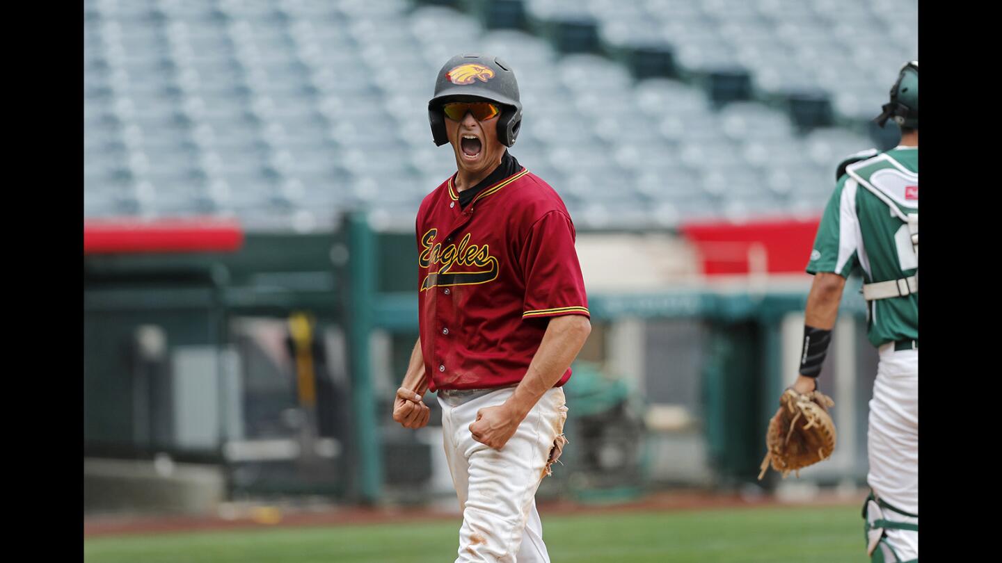 Estancia High's Joe Stukkie reacts after scoring the Eagles' first run against Costa Mesa during the second inning in the Battle for the Bell series at Angel Stadium in Anaheim on Tuesday, March 20.