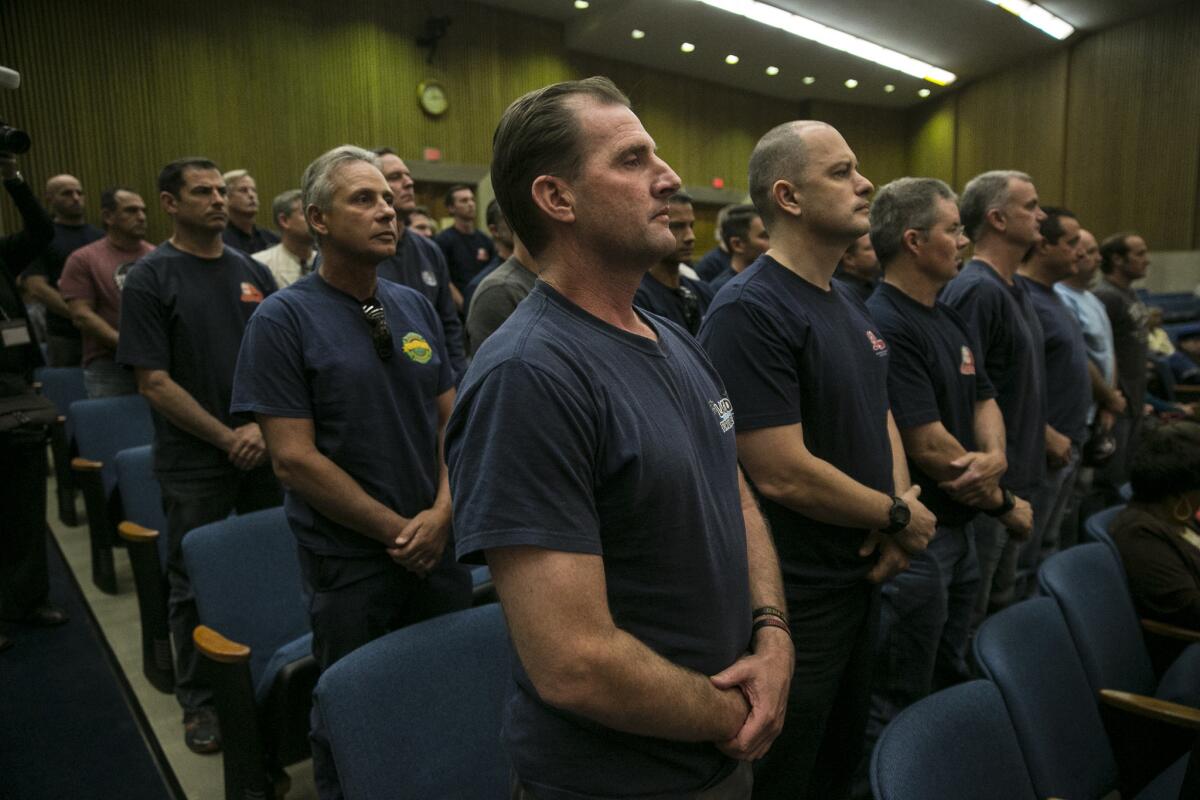 Los Angeles County firefighter Tim Brun joins dozens of others protesting the continued development and construction of cell towers by the Los Angeles Regional Interoperable Communications System.