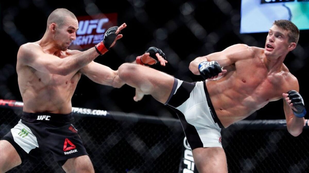 Stephen Thompson, right, kicks to the body of Rory MacDonald during a welterweight bout at UFC Fight Night 89 in Ottawa, Ontario, on June 19, 2016.