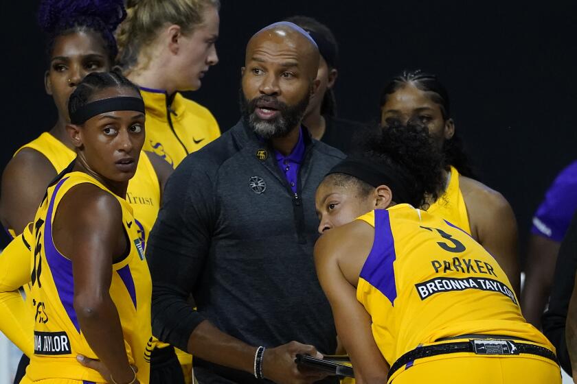 Los Angeles Sparks head coach Derek Fisher talks to guard Brittney Sykes (15) and forward Candace Parker.