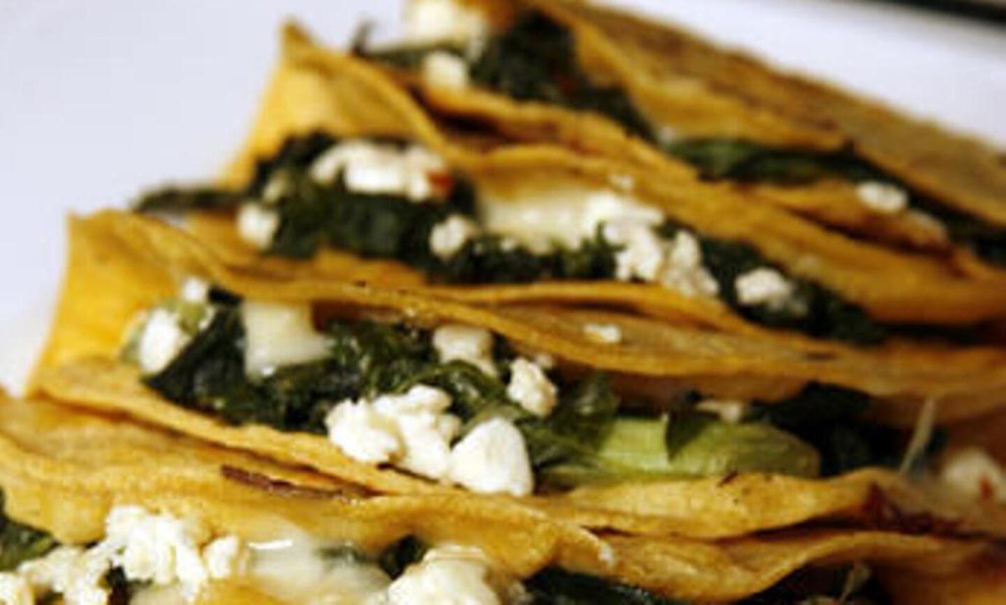 Quesadillas stuffed with greens and feta