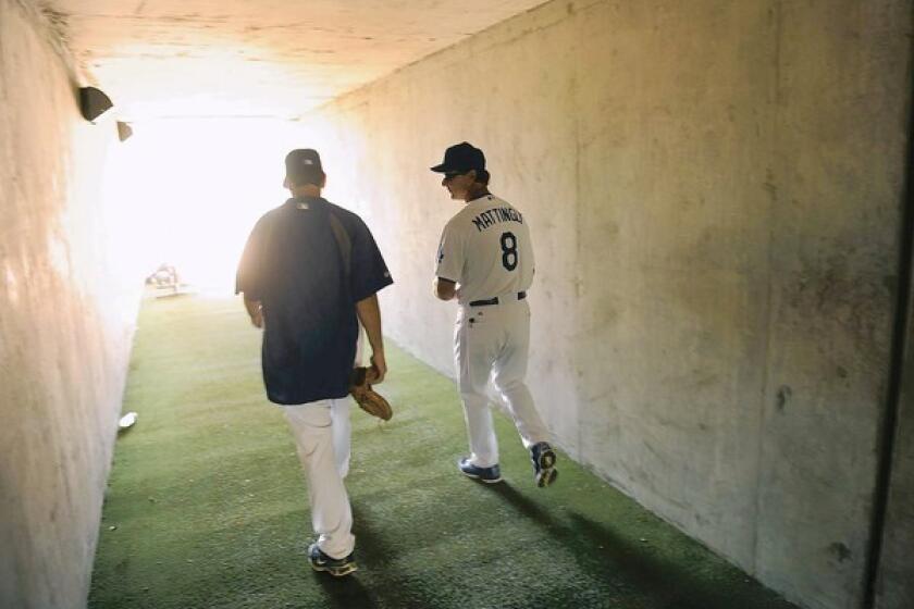Dodgers manager Don Mattingly walks through a tunnel leading to the field during spring training in Phoenix.