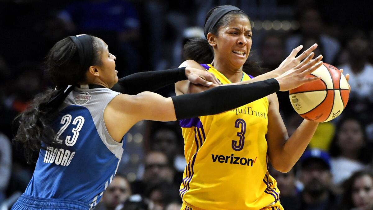 Sparks forward Candace Parks is pressured by Lynx forward Maya Moore during the first half of Game 4 on Sunday.