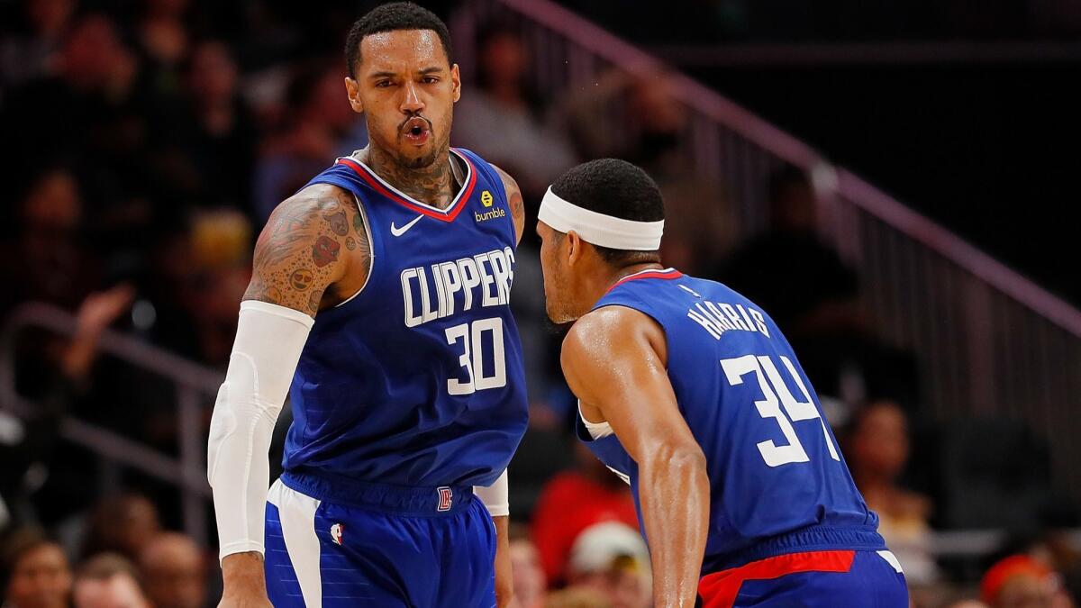 Clippers forwards Mike Scott (30) and Tobias Harris react after Scott made a three-point basket against the Hawks on Nov. 19 in Atlanta.