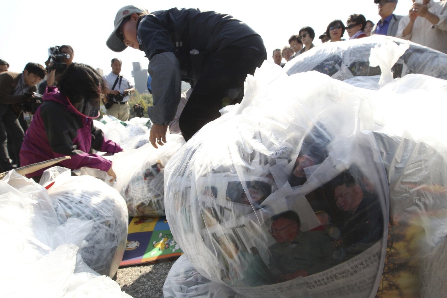 North Korean defectors in Paju, South Korea, prepare plastic bags containing leaflets condemning North Korean leader Kim Jong Un and his policies. The leaflets were attached to balloons and dropped over the border on Oct. 10.
