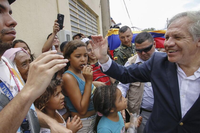 The Secretary-General of the Organization of American States (OAS), Uruguayan Luis Almagro (R), greets Venezuelans during his visit to the Divina Providencia migrant shelter in Cucuta, Colombia, on the border with Venezuela, on September 14, 2018. - Almagro is in Cucuta as part of a three-day visit to Colombia to discuss the Venezuelan migratory crisis which has been described as "the largest migration crisis" of the Western Hemisphere. According to the United Nations, about 2.3 million people left the oil-producing country since 2014, plunged into an acute economic crisis. (Photo by SCHNEYDER MENDOZA / AFP)SCHNEYDER MENDOZA/AFP/Getty Images ** OUTS - ELSENT, FPG, CM - OUTS * NM, PH, VA if sourced by CT, LA or MoD **