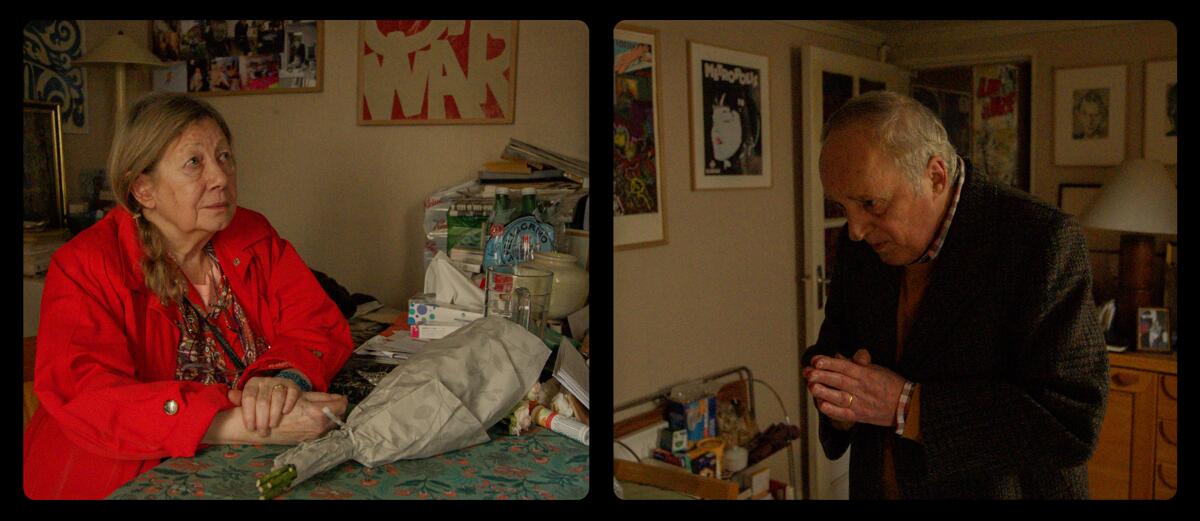 A woman in a red jacket with newspaper-wrapped flowers on a table and a man bowing his head as if in prayer.