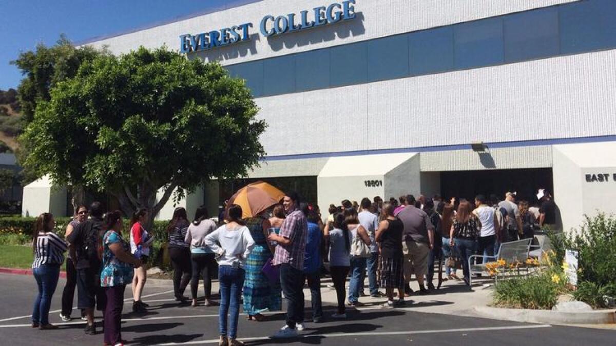 Students wait outside Everest College in the City of Industry in 2015 following the collapse of the for-profit Corinthian Colleges chain.