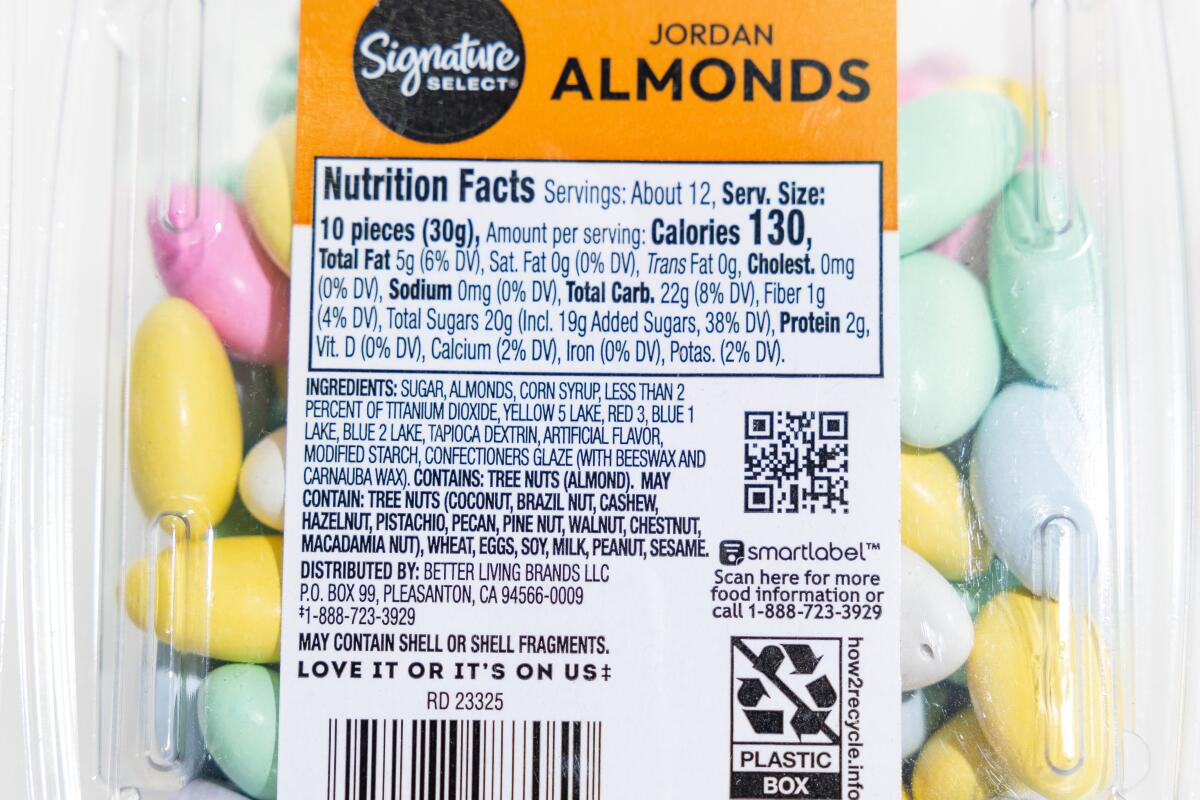 LOS ANGELES, CA, DECEMBER 26, 2024: Store bought grocery items that contain red dye #3, including Signature Select Jordan almonds, are photographed at the Los Angeles Times on December 26, 2024. High doses of red dye #3 were found to cause cancer in lab animals decades ago. A federal law known as the Delaney Clause says no compound shown to cause cancer in animals or humans can be in the food supply. The FDA acknowledged the cancer studies decades ago and used the findings to deny a request to approve the dye's use in cosmetics, however, red #3 was already being used in food, and for some reason its authorization has not yet been revoked. (Christina House / Los Angeles Times)