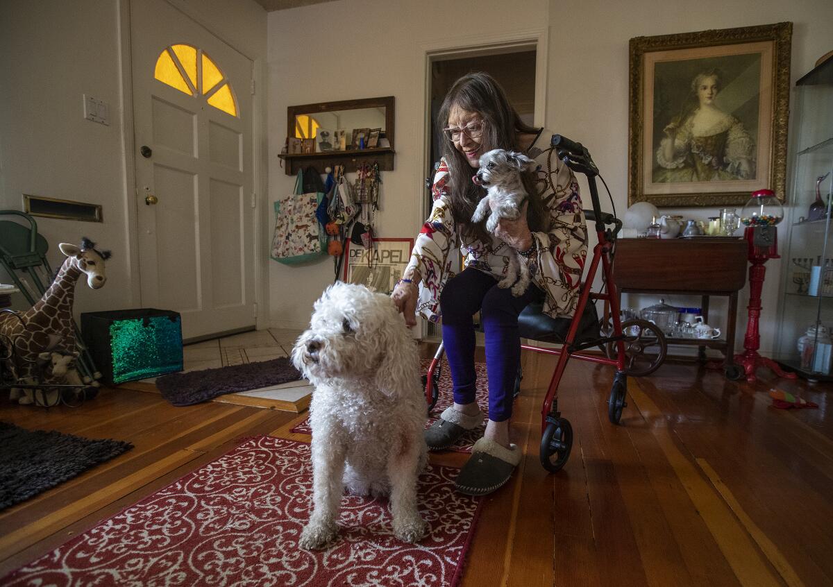 Maxine Shelley, who lives alone at her home in Valley Village, with her 2 dogs