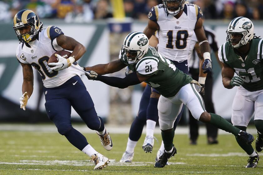 Rams running back Todd Gurley isn't slowed by the attempted tackle of Jets safety Marcus Gilchrist during a fourth-quarter drive.
