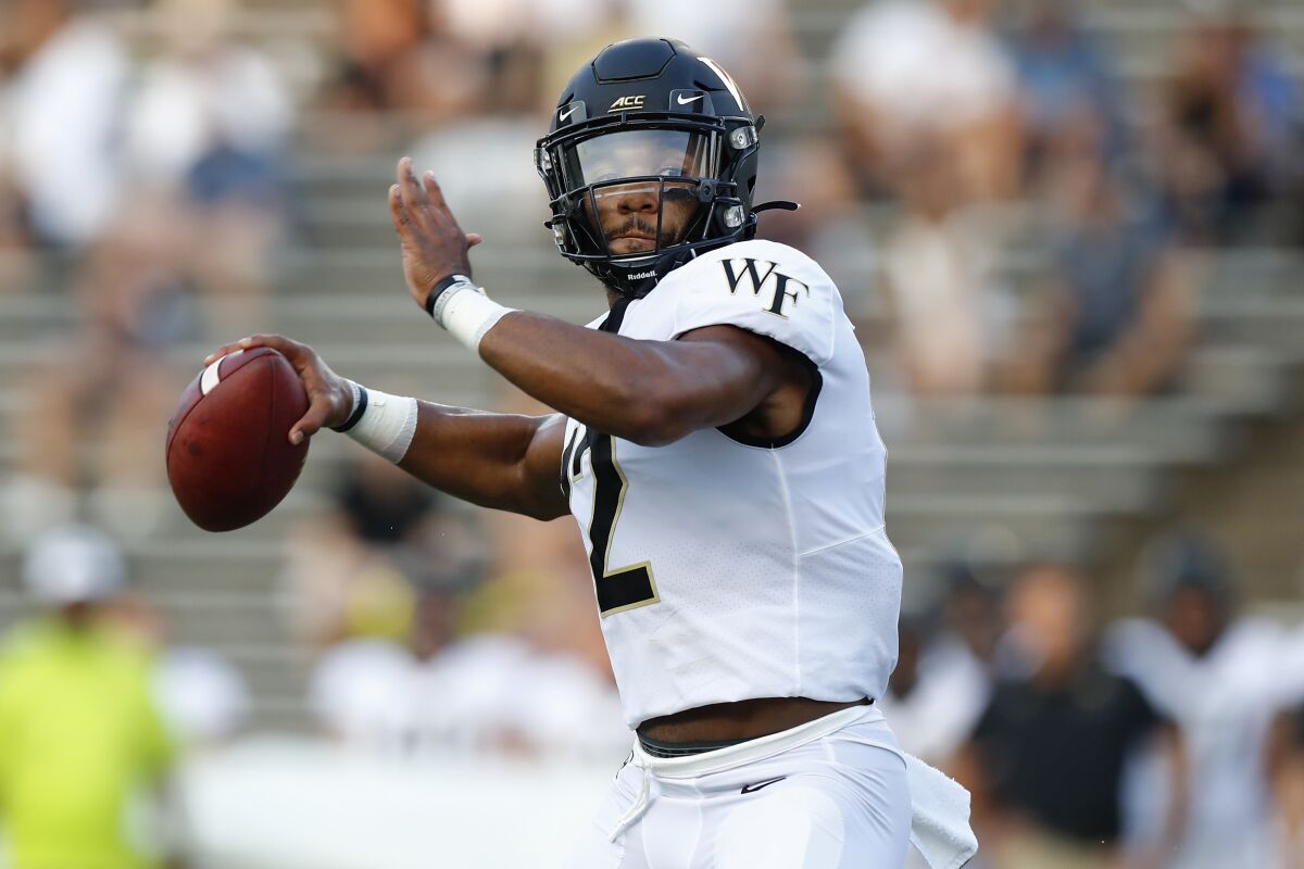 FILE - In this Sept. 6, 2019, file photo, then-Wake Forest quarterback Jamie Newman (12) looks to pass during an NCAA football game in Houston. Two transfers, Jamie Newman, from Wake Forest, and JT Daniels, from Southern Cal, are names to watch in Georgia’s five-player quarterback competition. Newman may be the favorite as practice started Monday because Daniels is still recovering from a knee injury at USC. (AP Photo/Matt Patterson, File)