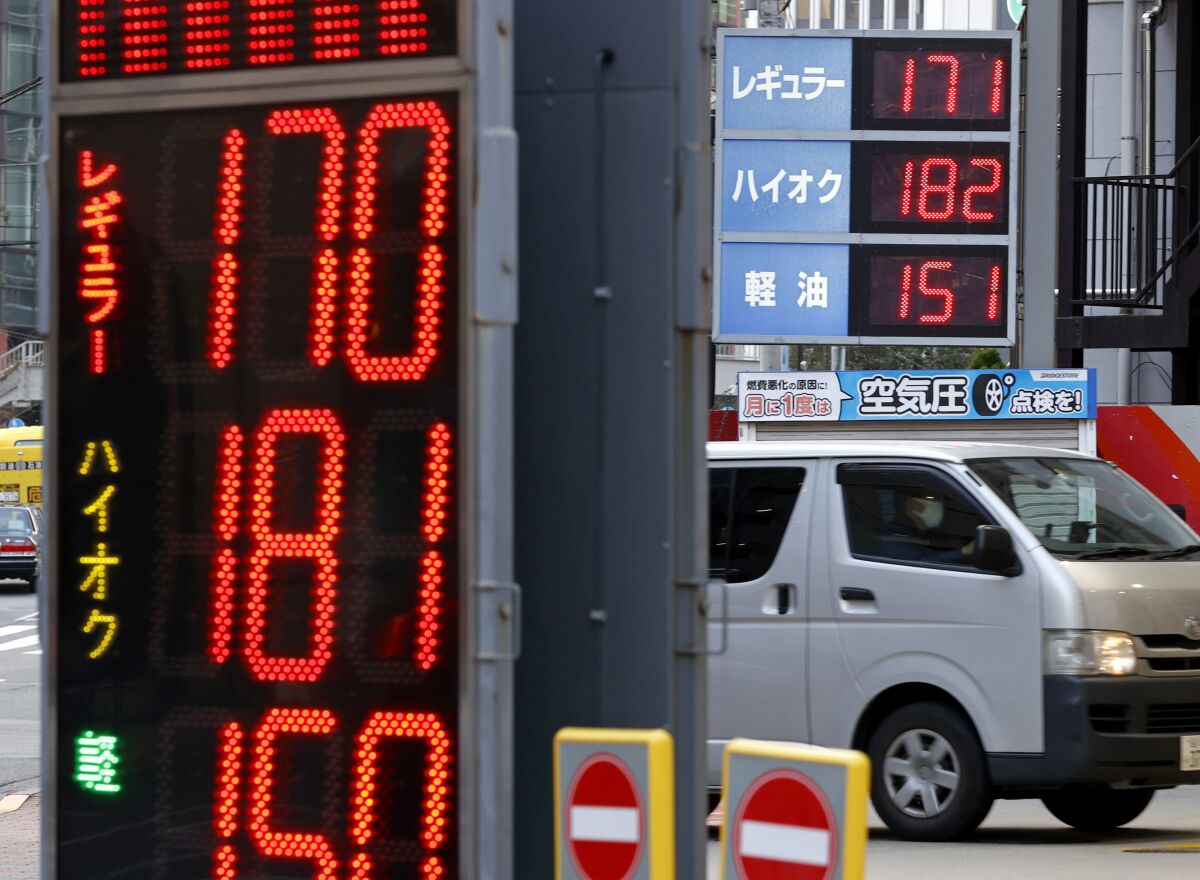 The price of regular gasoline shows 170 yen (1.32 USD) per liter at a gas station in Tokyo on March 16, 2022. Japan's trade deficit widened in March, pushed higher by soaring oil prices and a weakening yen.(Kyodo News via AP)