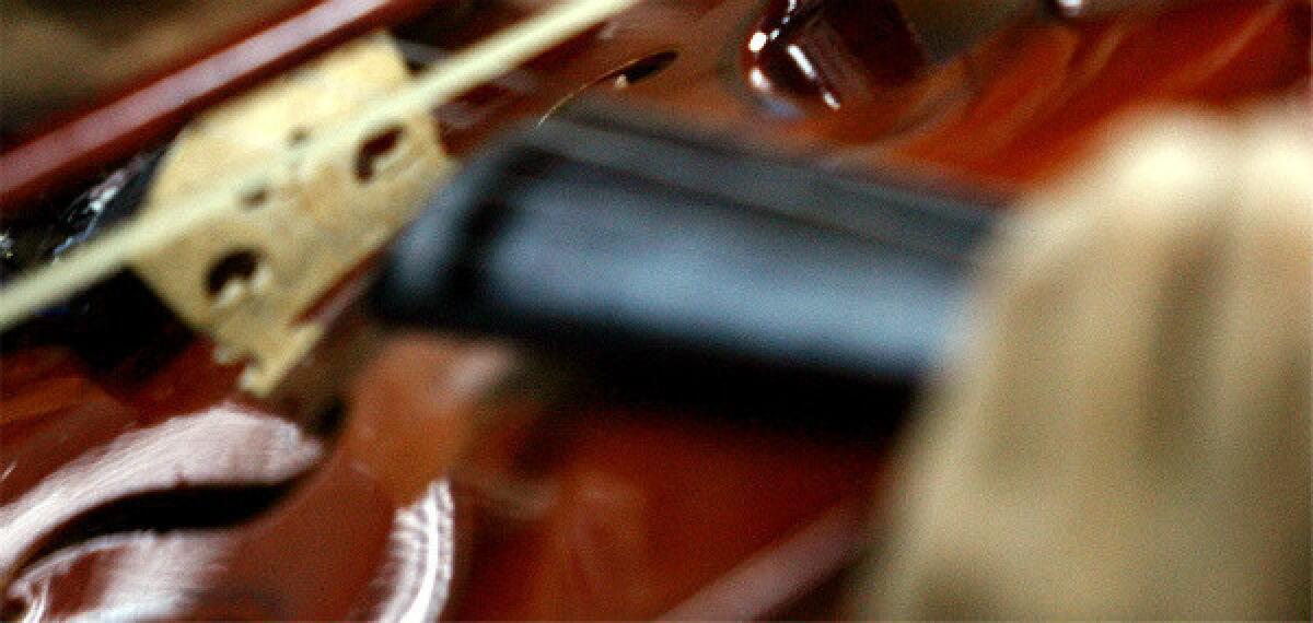 A student in the El Sistema program in Venezuela performs the violin.