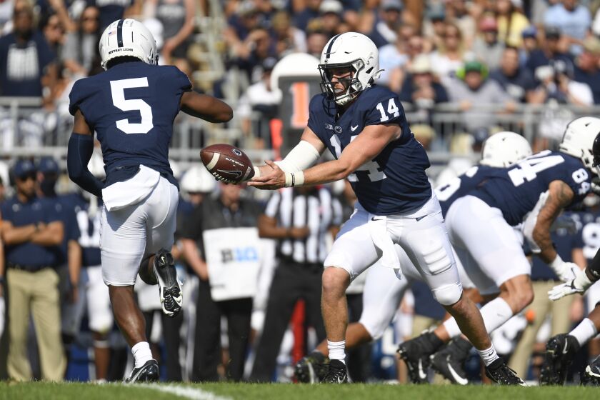 Penn State quarterback Sean Clifford (14) hands off to wide receiver Jahan Dotson (5) against Ball State during an NCAA college football game in State College, Pa.,on Saturday, Sept.11, 2021. (AP Photo/Barry Reeger)
