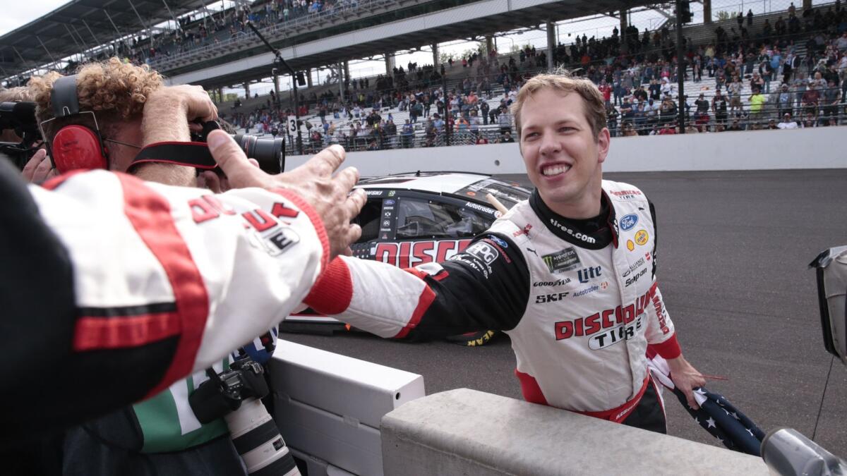 Brad Keselowski celebrates after winning the NASCAR Brickyard 400 auto race at Indianapolis Motor Speedway.