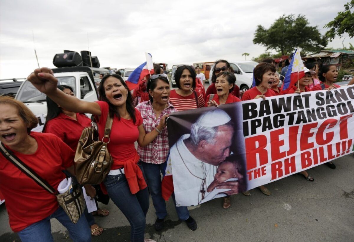 Filipino Catholics stage a demonstration against the passing of a reproductive health law in front of the Senate building on Monday.