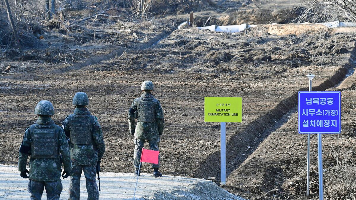 South Korean soldiers at Arrowhead Ridge, a site of Korean War battles, as a tactical road is built across the military demarcation line inside the DMZ.