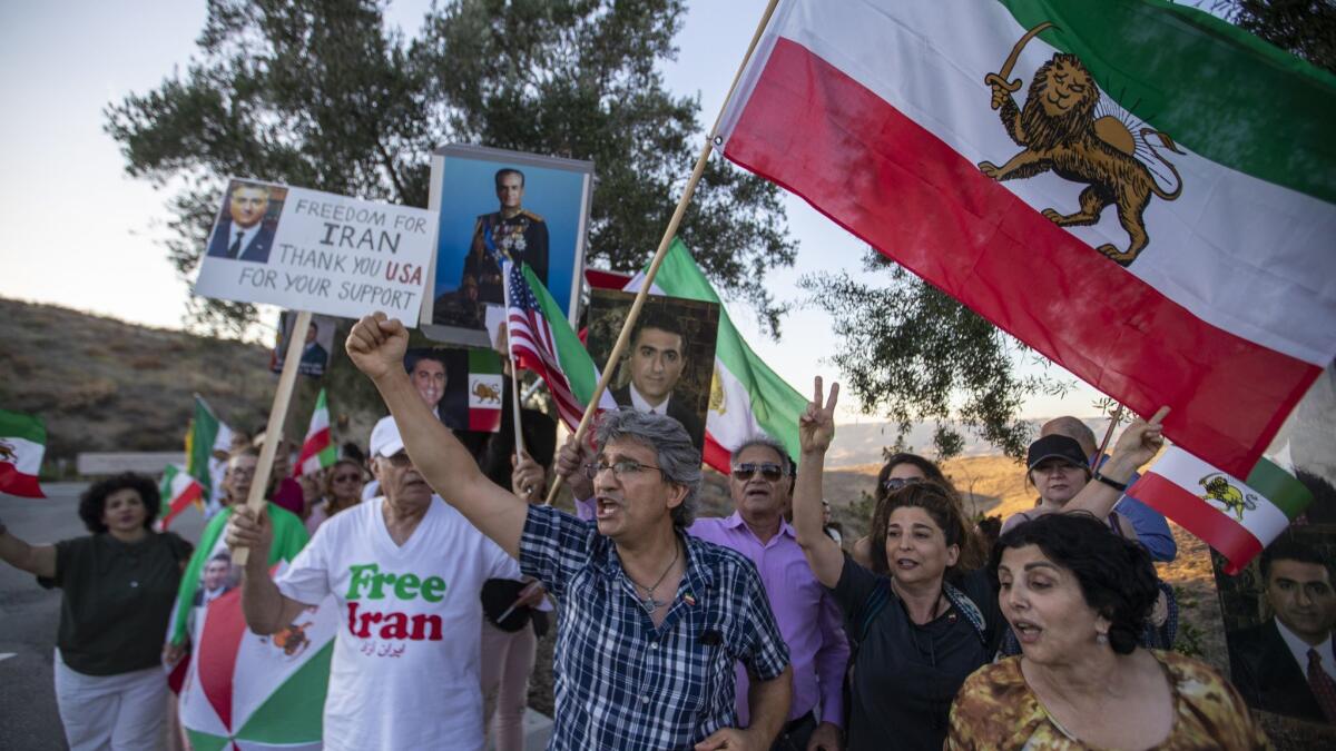 Protesters call attention to Iranians' struggle for freedom, justice, respect and human rights as U.S. Secretary of State Michael R. Pompeo speaks on "Supporting Iranian Voices" on Sunday at the Ronald Reagan Presidential Library in Simi Valley.
