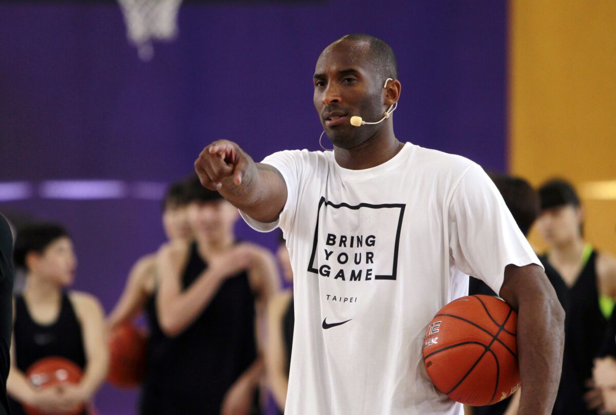 Retired basketball star Kobe Bryant gives instructions during a clinic with young Taiwanese players in Taipei in June.