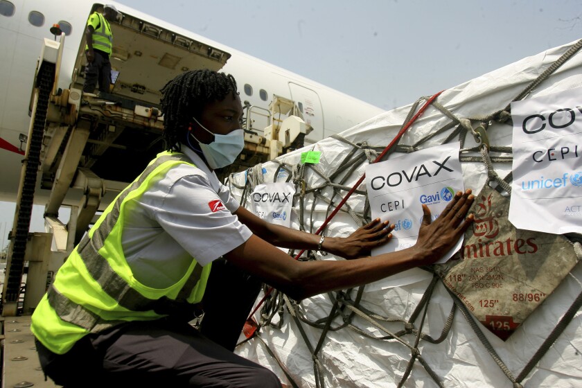 FILE - A shipment of COVID-19 vaccines distributed by the COVAX Facility arrives in Abidjan, Ivory Coast, Friday Feb. 25, 2021. The World Health Organization says a U.N.-backed program shipping coronavirus vaccines to many poor countries has now delivered 1 billion doses, but that milestone “is only a reminder of the work that remains” after hoarding and stockpiling in rich countries. The U.N. health agency said Sunday, Jan. 16, 2022 that a shipment of 1.1 million COVID-19 vaccine doses to Rwanda this weekend included the billionth dose supplied via the COVAX program. (AP Photo/Diomande Ble Blonde, File)