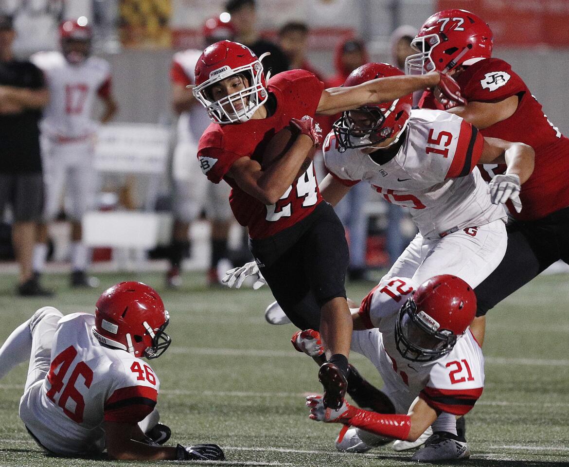 Burroughs' Luke Rogers breaks a couple Glendale tackles in the first quarter in a Pacific League football game Memorial Field in Burbank on Thursday, September 20, 2018. At halftime Burroughs was leading by three touchdowns.