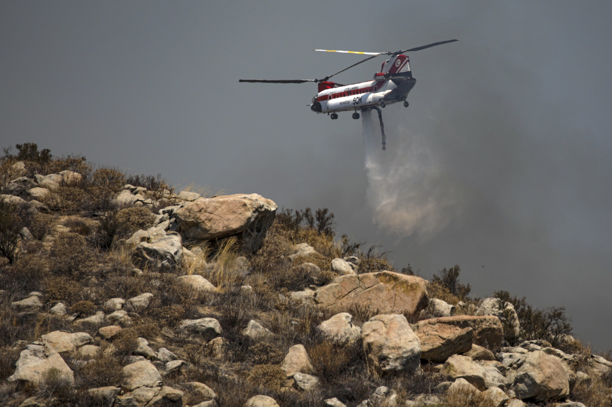 A Chinook helicopter makes a water drop in Avery Canyon.