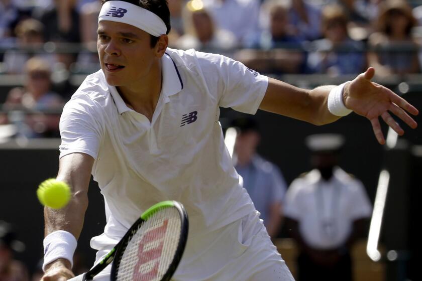 Canada's Milos Raonic returns to Spain's Albert Ramos-Vinolas during their Men's Singles Match on day six at the Wimbledon Tennis Championships in London Saturday, July 8, 2017. (AP Photo/Alastair Grant)