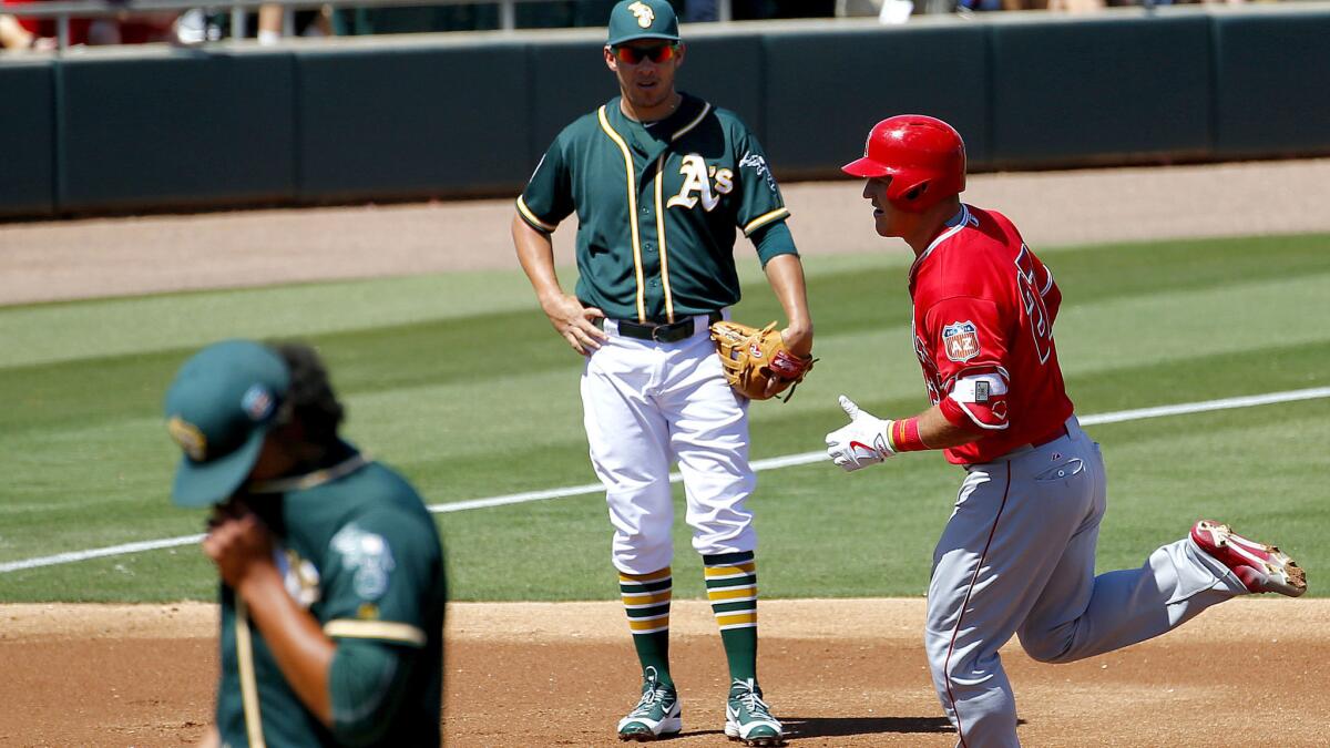 Angels center fielder Mike Trout rounds the bases after hitting a solo home run against the A's in the first inning Friday.