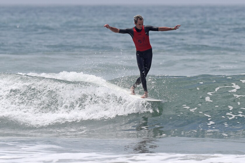 Harrison Roach cross steps to the front of his board as he rides a wave Thursday during the U.S. Open of Surfing.