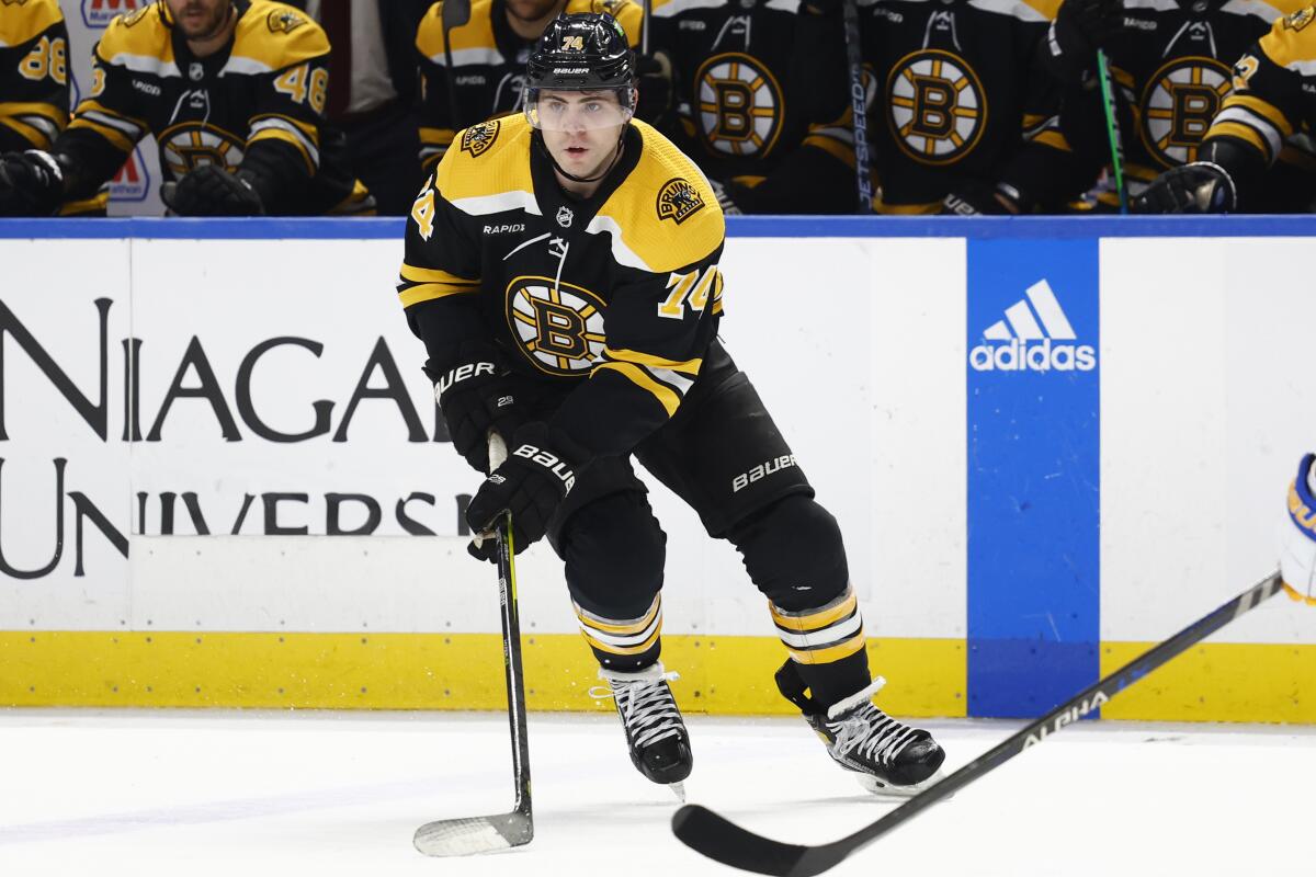 Boston Bruins left wing Jake DeBrusk (74) controls the puck past the blue line during the second period of the team's NHL hockey game against the Buffalo Sabres on Saturday, Nov. 12, 2022, in Buffalo, N.Y. (AP Photo/Jeffrey T. Barnes)