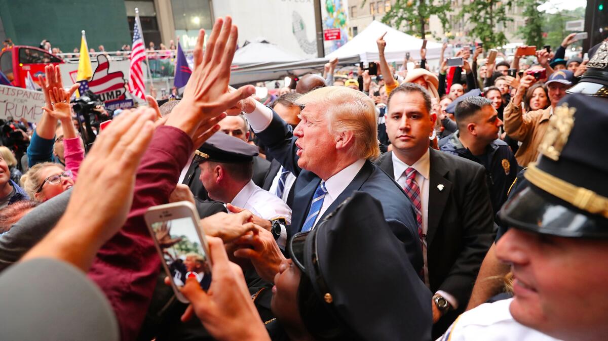 Donald Trump greets supporters outside of Trump Towers in Manhattan Saturday in New York City. The Trump campaign has faced numerous calls for him to step aside after a recording from 2005 revealed lewd comments he'd made about women.