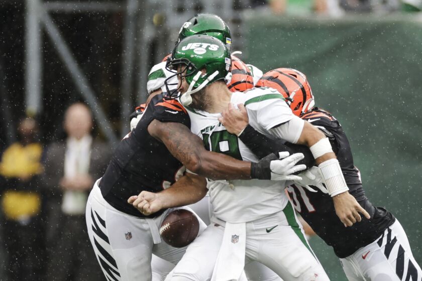 New York Jets quarterback Joe Flacco, center, is sacked by Cincinnati Bengals' Trey Hendrickson, right, and BJ Hill, left, during the second half of an NFL football game Sunday, Sept. 25, 2022, in East Rutherford, N.J. (AP Photo/Adam Hunger)