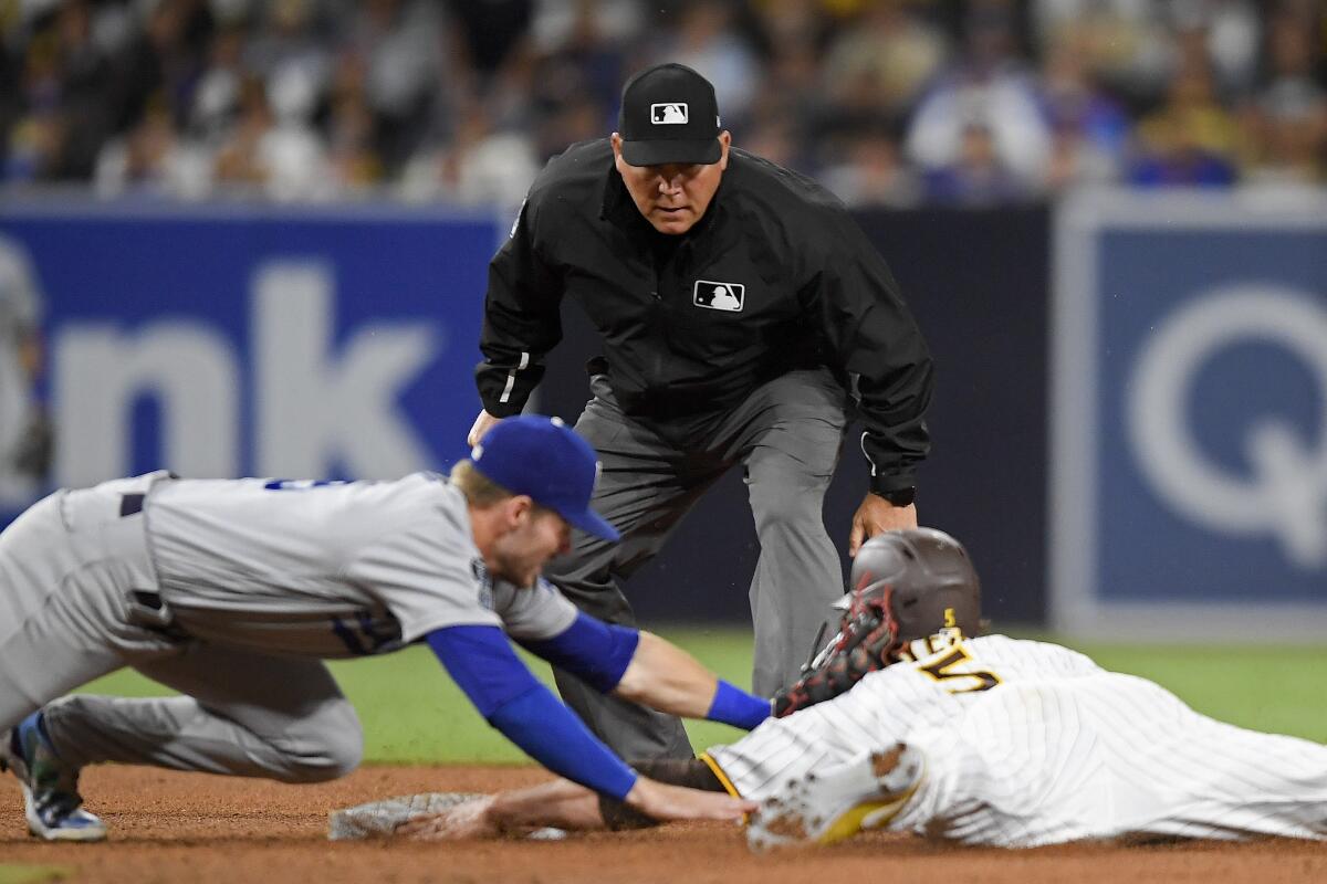 San Diego Padres right fielder Wil Myers steals second base ahead of the tag of Dodgers second baseman Gavin Lux.