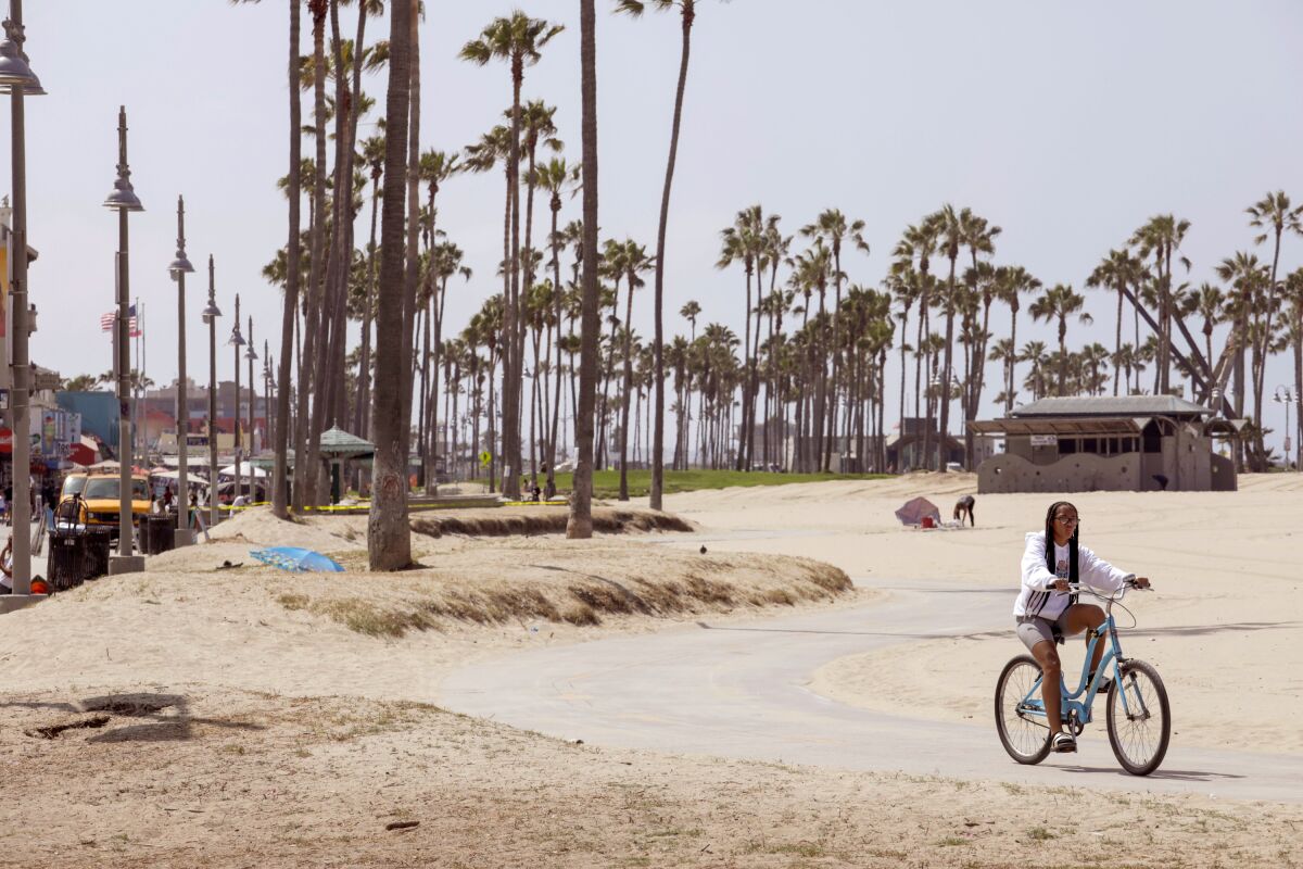 A woman riding her bike at Venice Beach